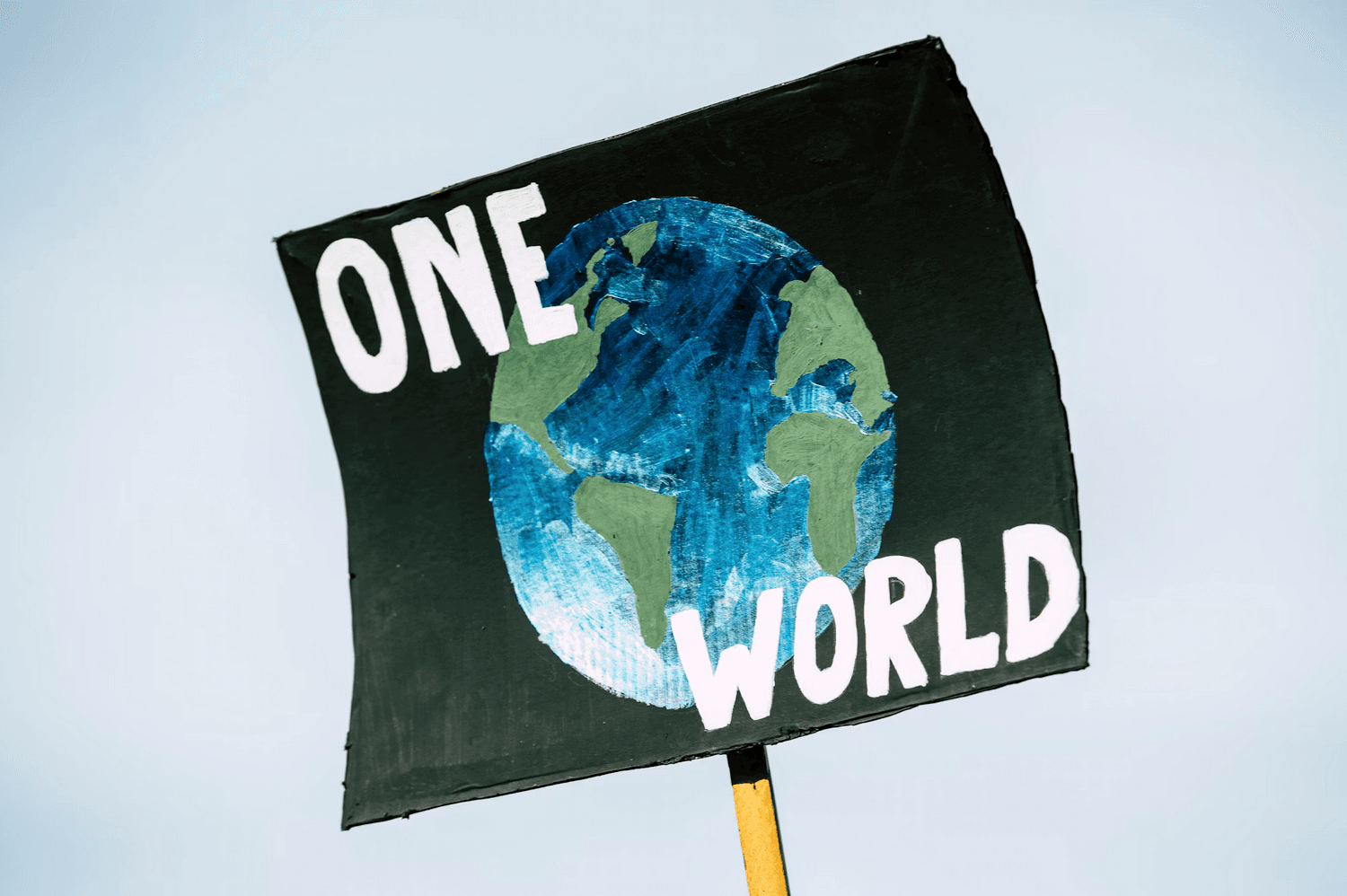 'One World' written on a poster depicting the Eartyh
