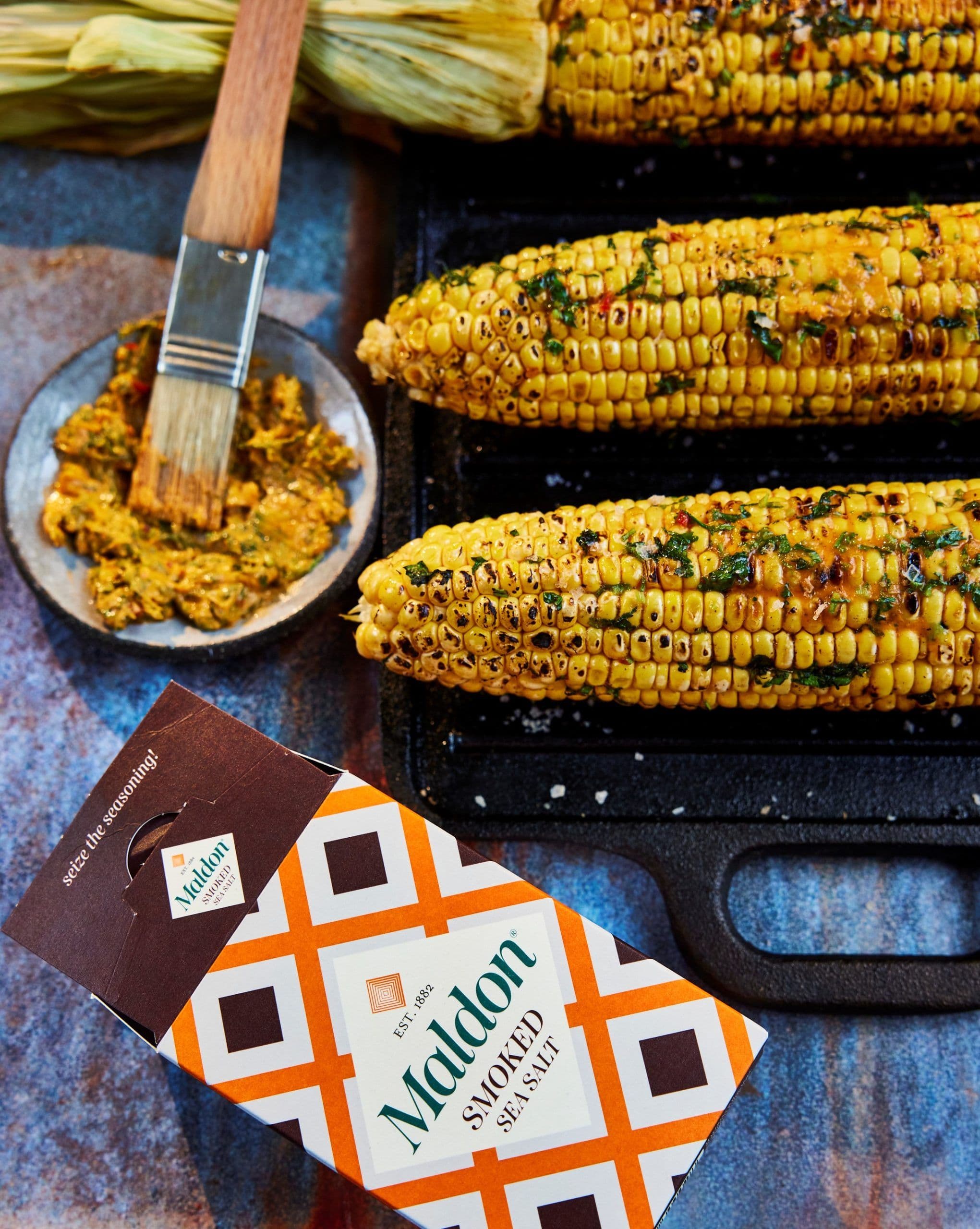 Charred BBQ sweetcorn with smoked salt, harissa and coriander butter